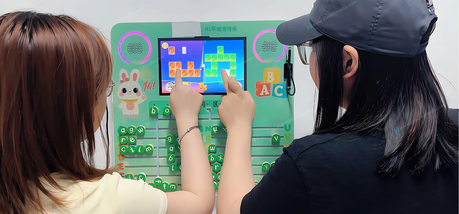 Two-player competition mode on interactive preschool learning wall building cooperation skills